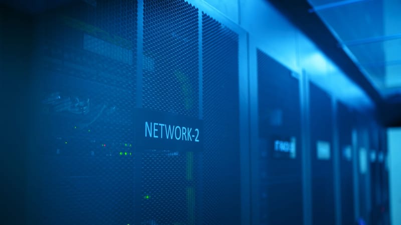 A modern server room featuring network equipment with blue illumination. Ideal for technology themes.